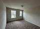 Bedroom featuring plush carpeting, two bright windows, and neutral walls. This room is move-in ready at 257 Depot Landing Rd # 39, Auburn, GA 30011