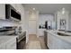 Bright kitchen with stainless steel appliances, white cabinetry and countertops at 257 Depot Landing Rd # 39, Auburn, GA 30011