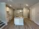 Open kitchen featuring a granite island, stainless steel sink, and ample cabinet space at 257 Depot Landing Rd # 39, Auburn, GA 30011