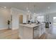Bright kitchen with a white island, modern appliances, and hardwood floors flowing into an open living space at 257 Depot Landing Rd # 39, Auburn, GA 30011