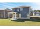 Lush backyard showcasing a modern two-story home with a covered patio and green lawn at 266 Tulip Dr, Covington, GA 30016
