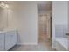Bright bathroom featuring a single sink vanity and tile floors leading to a closet space at 266 Tulip Dr, Covington, GA 30016