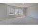 Carpeted bedroom with multiple windows providing natural light at 266 Tulip Dr, Covington, GA 30016