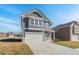Charming two-story home with gray siding, white trim, a covered entrance, and a two-car garage at 266 Tulip Dr, Covington, GA 30016