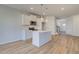Open concept kitchen with island, stainless appliances, and connection to foyer and stairs at 266 Tulip Dr, Covington, GA 30016