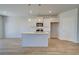 Bright kitchen with an island, stainless steel appliances, and a view into the living area at 266 Tulip Dr, Covington, GA 30016