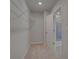 Well-organized walk-in closet with shelving and a doorway leading to a tiled bathroom at 266 Tulip Dr, Covington, GA 30016