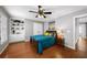 Comfortable bedroom featuring hardwood floors, ceiling fan, and built-in shelving at 3857 Felton Hill Sw Rd # 9, Smyrna, GA 30082