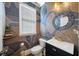 Stylish powder room featuring unique wallpaper, a mosaic mirror, and modern fixtures at 3857 Felton Hill Sw Rd # 9, Smyrna, GA 30082