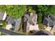 Aerial view showcases the home's roof design, driveway, and landscaping, nestled among mature trees at 4566 Fountain Ne Dr, Marietta, GA 30067