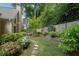Backyard garden with a stepping stone walkway, flowering plants, and lush green lawn at 4566 Fountain Ne Dr, Marietta, GA 30067