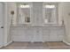 Elegant bathroom boasting dual sinks with white cabinetry and a central tower cabinet for storage at 4566 Fountain Ne Dr, Marietta, GA 30067