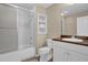 A bathroom featuring a shower and tub combination with a sleek sliding door at 4566 Fountain Ne Dr, Marietta, GA 30067