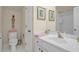 Bright bathroom with white vanity, shower, and decorated with wall art and pink towels at 4566 Fountain Ne Dr, Marietta, GA 30067