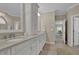 Beautiful bathroom features dual sinks with white cabinets, complemented by natural light and tile flooring at 4566 Fountain Ne Dr, Marietta, GA 30067