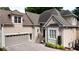 Elegant home featuring a two-car garage, beautiful landscaping, and a welcoming entrance with a charming bench at 4566 Fountain Ne Dr, Marietta, GA 30067