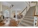 Spacious foyer with hardwood floors, staircase, and a view to other rooms at 4566 Fountain Ne Dr, Marietta, GA 30067