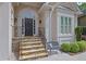 Inviting front entrance with a stone staircase and a cozy bench for relaxing at 4566 Fountain Ne Dr, Marietta, GA 30067