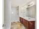 Bathroom featuring a double vanity with dark wood cabinets, a shower, and modern fixtures at 7630 Volion Pkwy, Fairburn, GA 30213