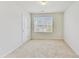 Bedroom featuring neutral walls, plush carpeting, natural light, and inviting atmosphere at 7630 Volion Pkwy, Fairburn, GA 30213