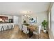 Bright dining area featuring modern chandelier and an open view of the kitchen with a breakfast bar at 7630 Volion Pkwy, Fairburn, GA 30213