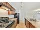 Well-lit kitchen with dark cabinets, stainless steel appliances, and an island at 7630 Volion Pkwy, Fairburn, GA 30213