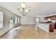 Bright living room featuring wood floors, recessed lighting, and an adjacent kitchen at 7630 Volion Pkwy, Fairburn, GA 30213