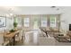 Spacious living room with lots of natural light, neutral walls, and an adjacent dining area at 7630 Volion Pkwy, Fairburn, GA 30213