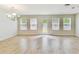 Bright and airy living area with lots of natural light coming in and a hardwood floor at 7630 Volion Pkwy, Fairburn, GA 30213