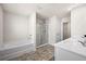 Bright bathroom featuring a soaking tub, walk-in shower, and double vanity with quartz countertop at 853 Bentley Drive Dr, Fairburn, GA 30213