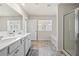 Well-lit bathroom with double vanity, a separate shower and tub, plus modern fixtures at 853 Bentley Drive Dr, Fairburn, GA 30213