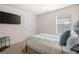Cozy bedroom featuring a television, large bed, and natural light from the window at 853 Bentley Drive Dr, Fairburn, GA 30213