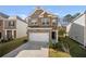 Inviting two-story brick home with a two-car garage, well-kept lawn, and charming facade at 853 Bentley Drive Dr, Fairburn, GA 30213