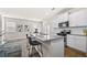 Modern kitchen with white cabinets, granite countertops, stainless steel appliances, and a stylish breakfast bar at 853 Bentley Drive Dr, Fairburn, GA 30213