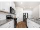 Modern kitchen featuring white cabinetry, stainless steel appliances, and beautiful granite countertops at 853 Bentley Drive Dr, Fairburn, GA 30213