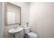 Functional powder room featuring a pedestal sink, a white toilet, and neutral wall paint at 853 Bentley Drive Dr, Fairburn, GA 30213