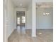 Bright entryway showcasing hardwood floors, elegant lighting, and open access to the dining area at 107 St Annes Pl, Covington, GA 30016