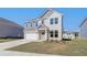 Charming two-story home featuring a two-car garage, manicured lawn, and inviting front porch at 107 St Annes Pl, Covington, GA 30016