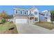 Inviting two-story home with a two-car garage, well-kept lawn, and lovely exterior design at 107 St Annes Pl, Covington, GA 30016