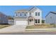 Charming two-story home featuring a two-car garage, manicured lawn, and inviting front porch at 107 St Annes Pl, Covington, GA 30016