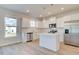 A bright kitchen featuring white cabinets, stainless appliances, and a center island at 107 St Annes Pl, Covington, GA 30016
