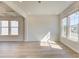 Bright living room featuring hardwood floors and an abundance of natural light through large windows at 107 St Annes Pl, Covington, GA 30016