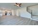 Open-concept living space connecting the living room, kitchen, and staircase at 107 St Annes Pl, Covington, GA 30016