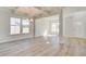 Bright living room featuring hardwood floors, coffered ceilings, elegant lighting, and an open layout at 107 St Annes Pl, Covington, GA 30016