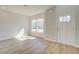 Bright living room featuring hardwood floors and an abundance of natural light through large windows at 107 St Annes Pl, Covington, GA 30016