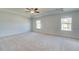 Spacious main bedroom with neutral walls, carpet, and tray ceiling at 107 St Annes Pl, Covington, GA 30016