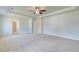 Large main bedroom with carpet, tray ceiling, and multiple entry points at 107 St Annes Pl, Covington, GA 30016