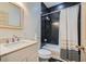 Well-lit bathroom features tub with shower, modern vanity, and black and white tile at 2499 Peachtree Ne Rd # 108, Atlanta, GA 30305