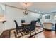 Chic dining area with stylish chandelier, seating for four, and decorative rug on hardwood floors at 2499 Peachtree Ne Rd # 108, Atlanta, GA 30305