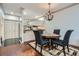 Cozy dining area adjacent to kitchen features elegant chandelier, seating, and reflective mirrored wall at 2499 Peachtree Ne Rd # 108, Atlanta, GA 30305